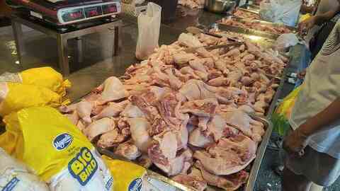 Fresh chicken pieces displayed at a market poultry stall
