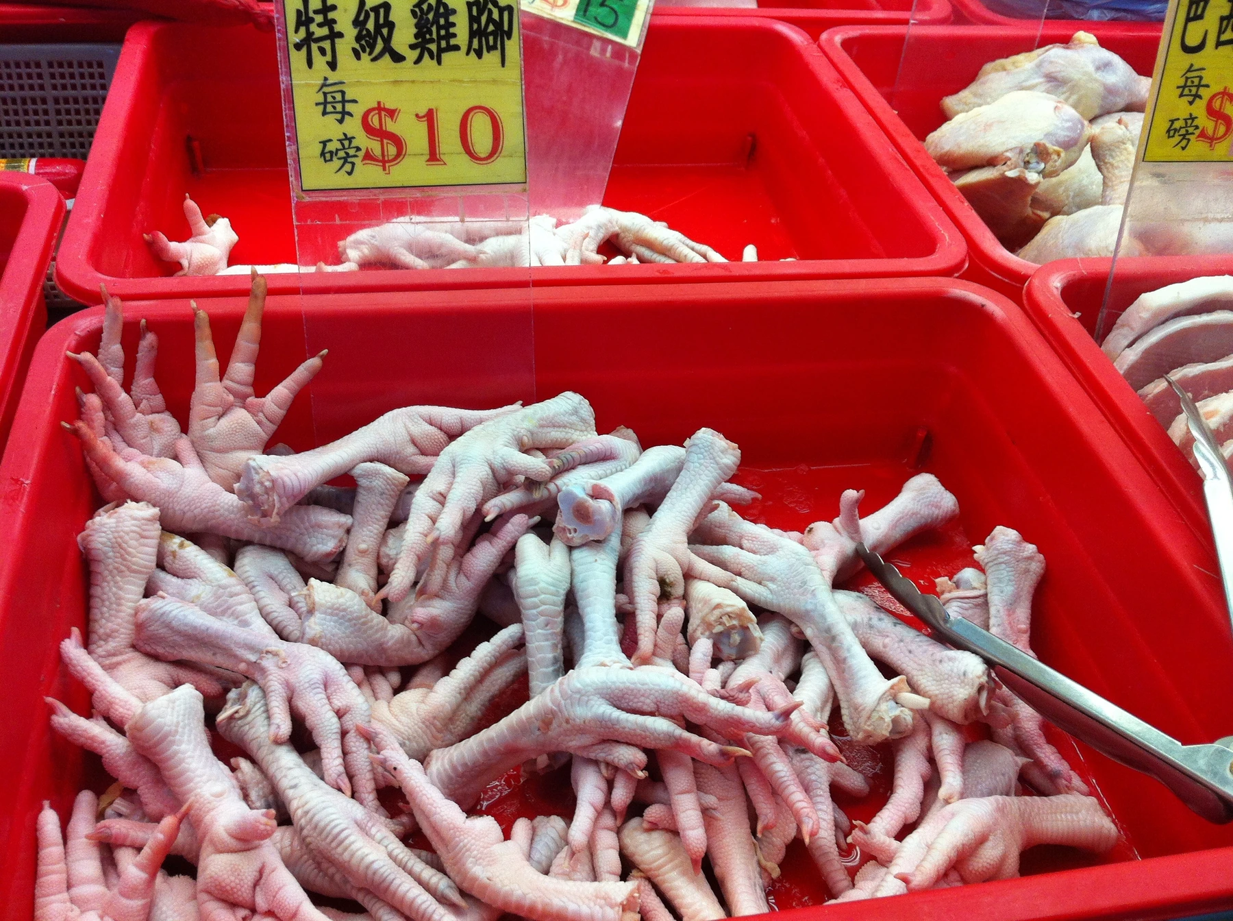 Uncooked chicken feet at a market